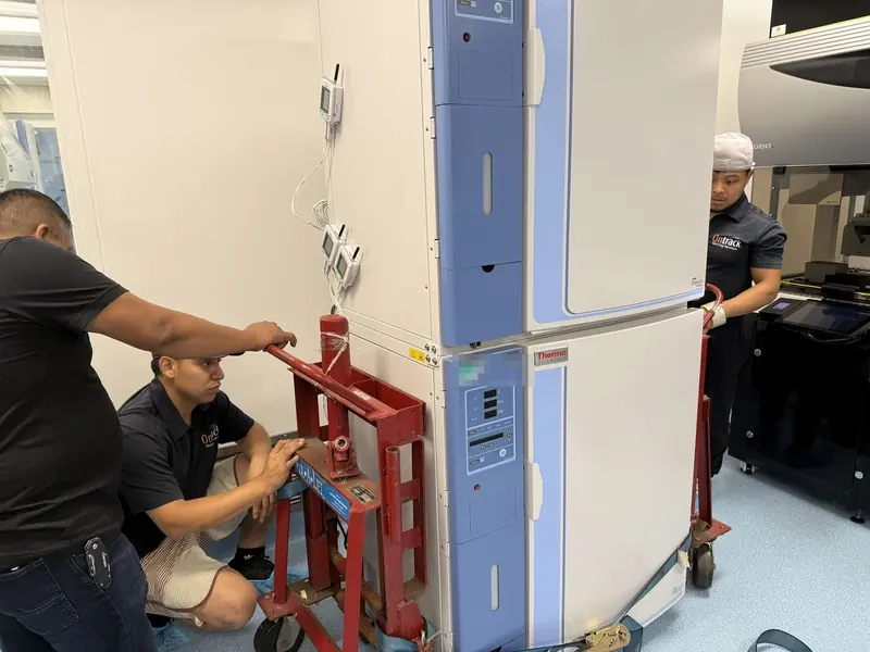Ontrack Moving crew moving a stacked pair of laboratory incubators with lift jacks inside a Bay Area biotech lab