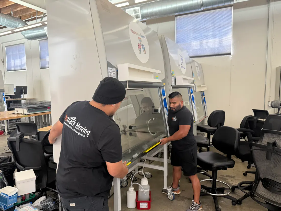 Two Ontrack Moving crew members with a biosafety cabinet during the Wild Type Foods laboratory relocation in San Francisco