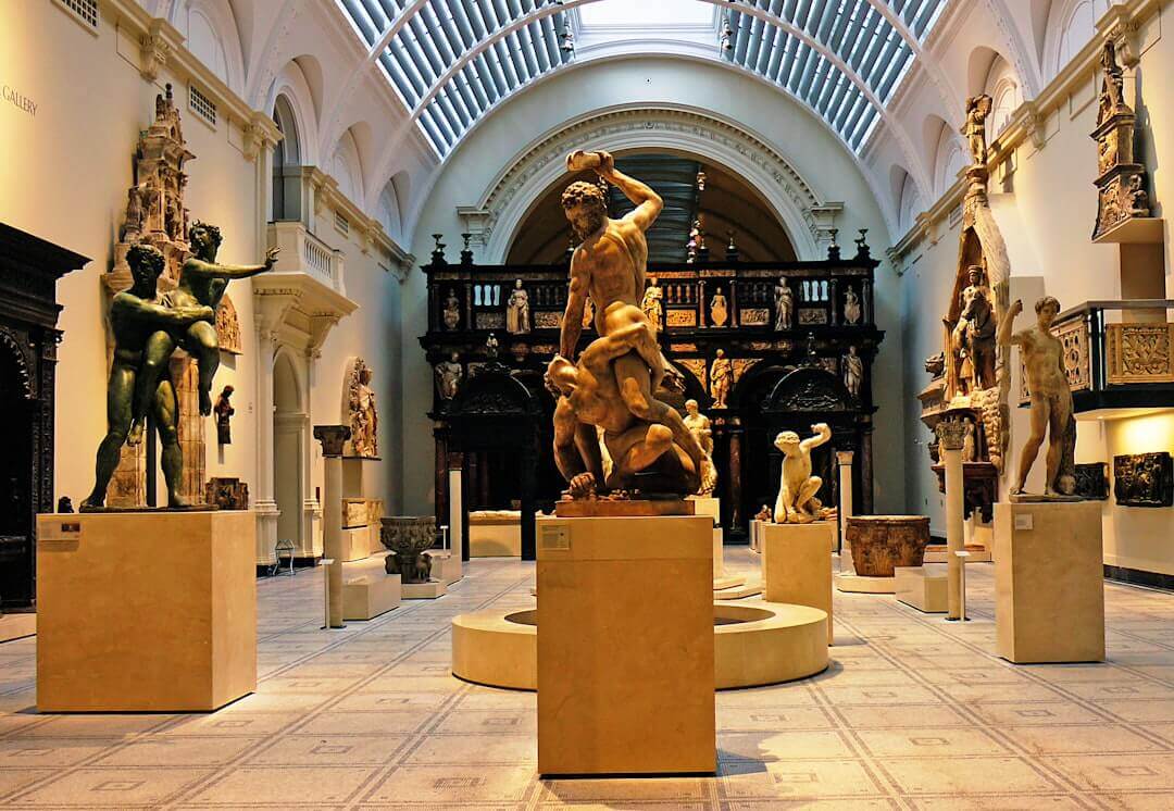 Classical marble and bronze sculptures in museum setting