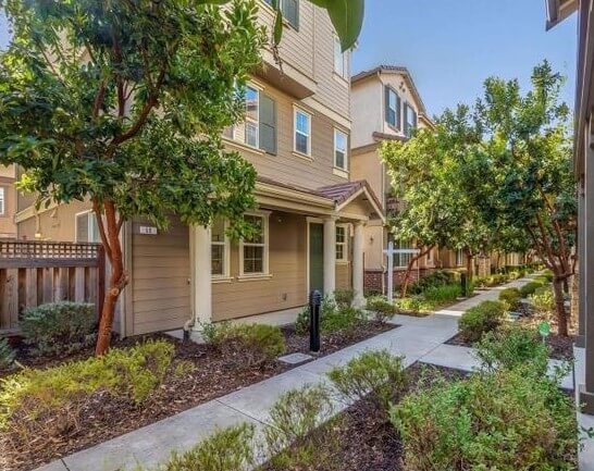 Three-story townhomes with walkway-only front entries and no curbside driveway, the access pattern Ontrack Moving crews plan for on Hayward residential moves