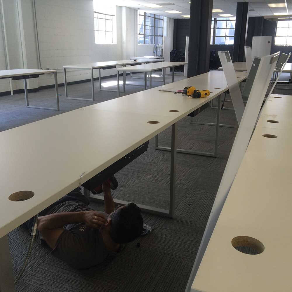 Office desk assembly during commercial relocation