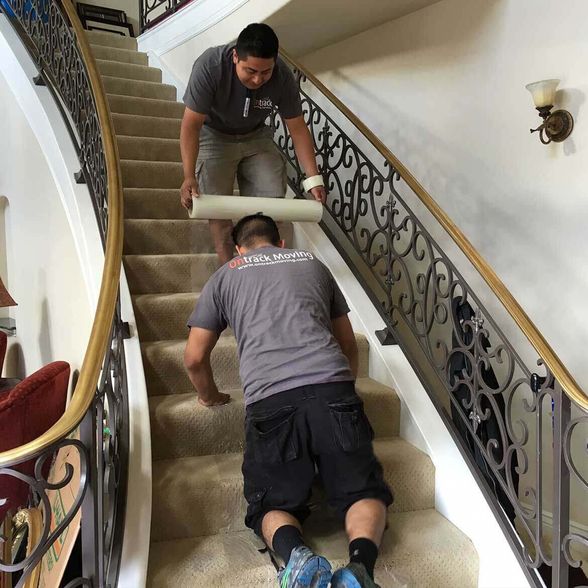 Ontrack Moving crew protecting floors during residential move