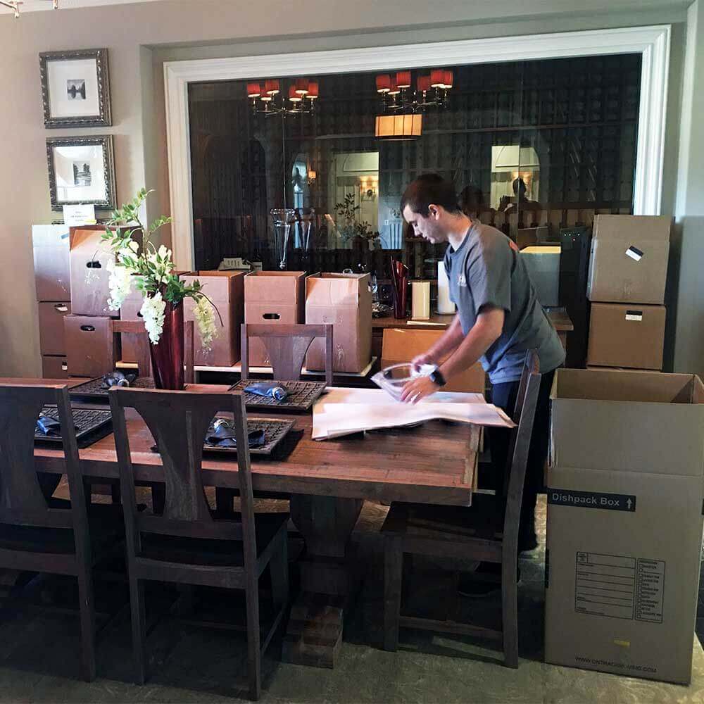 Ontrack Moving crew packing delicate china and glassware