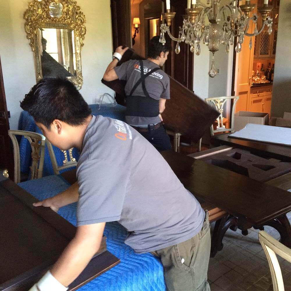 Ontrack Moving crew disassembling furniture during San Francisco Victorian home move