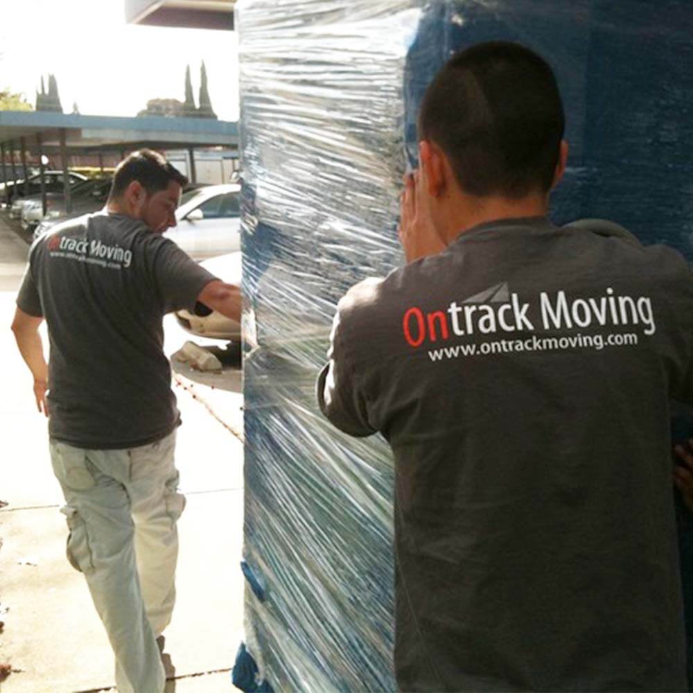 Ontrack Moving crew carefully relocating armoire during Scottsdale residential move